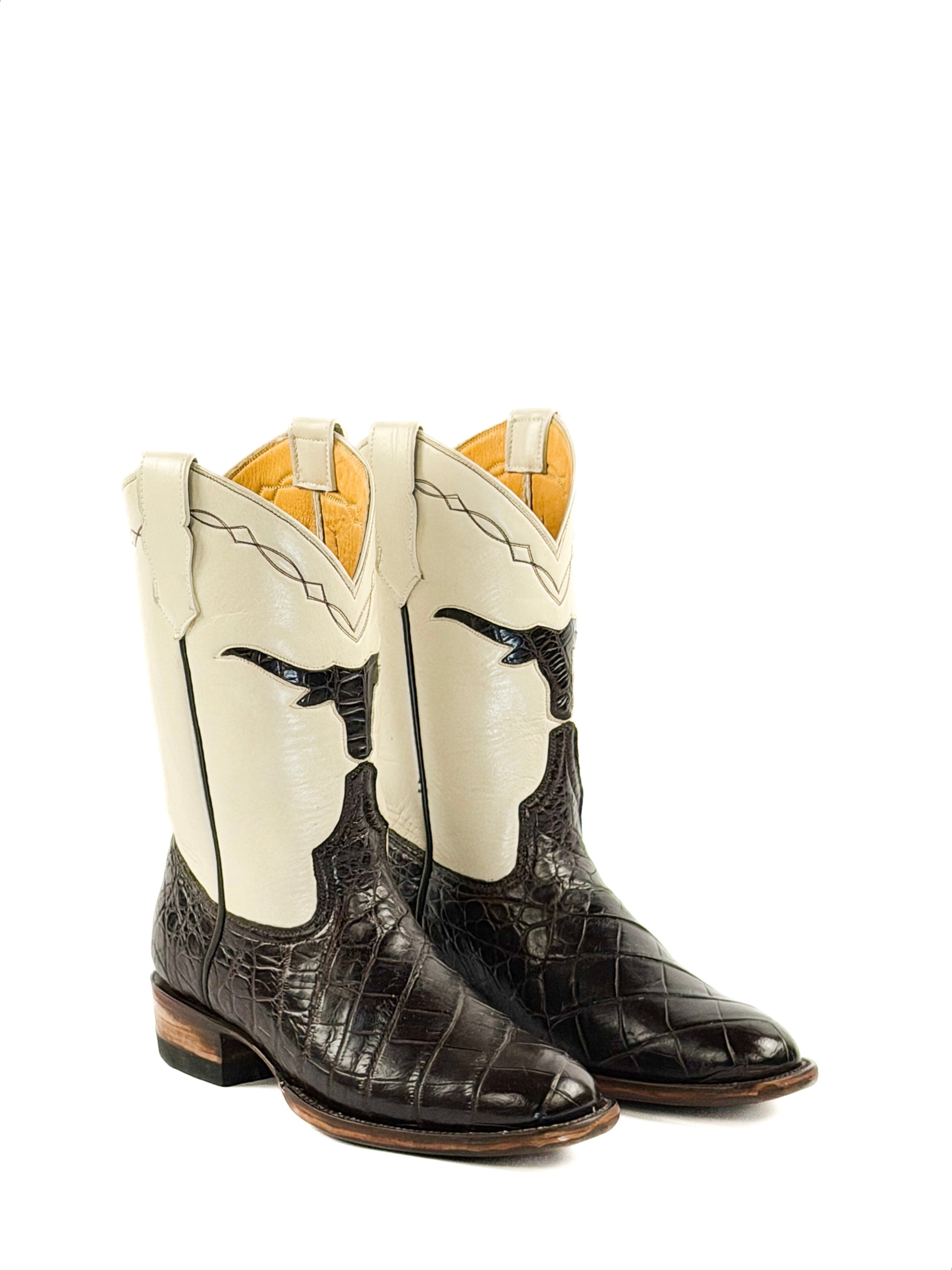 Pair of dark brown and cream cowboy boots with a shaped longhorn