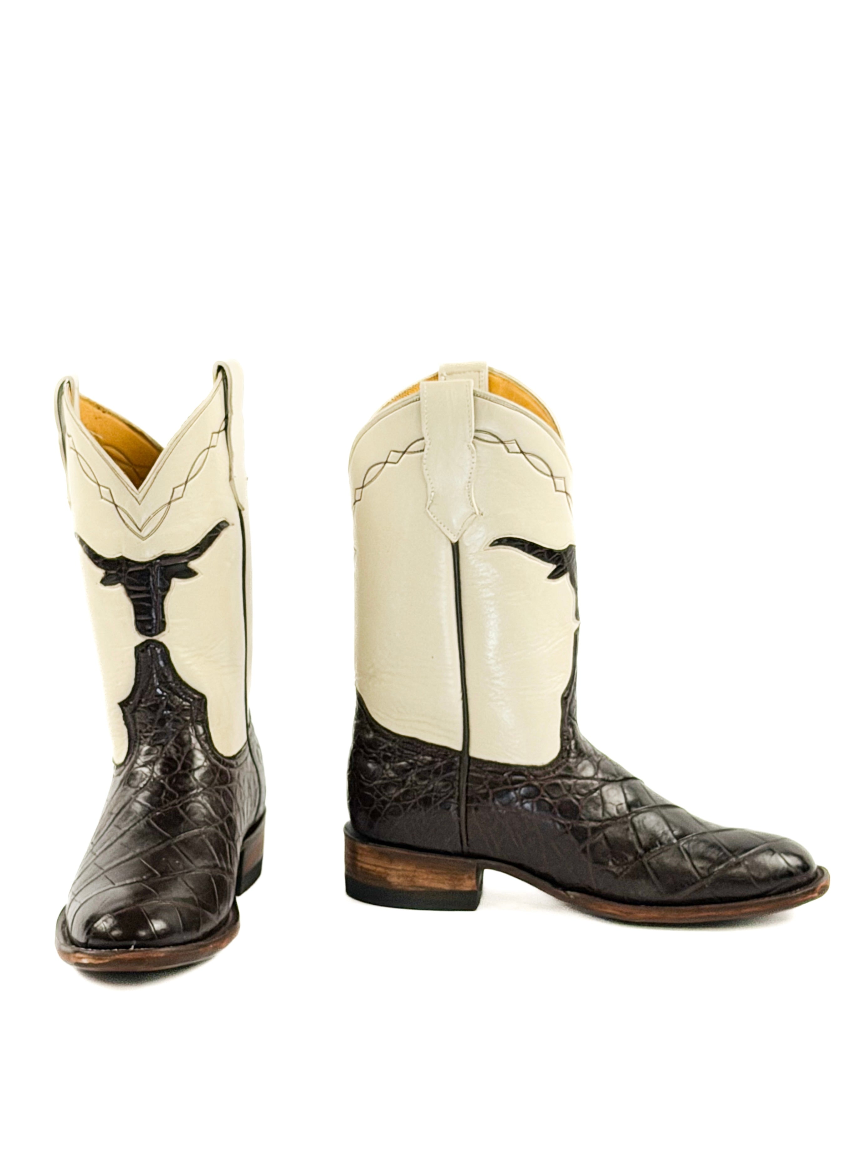 Pair of dark brown and cream cowboy boots with a longhorn shape