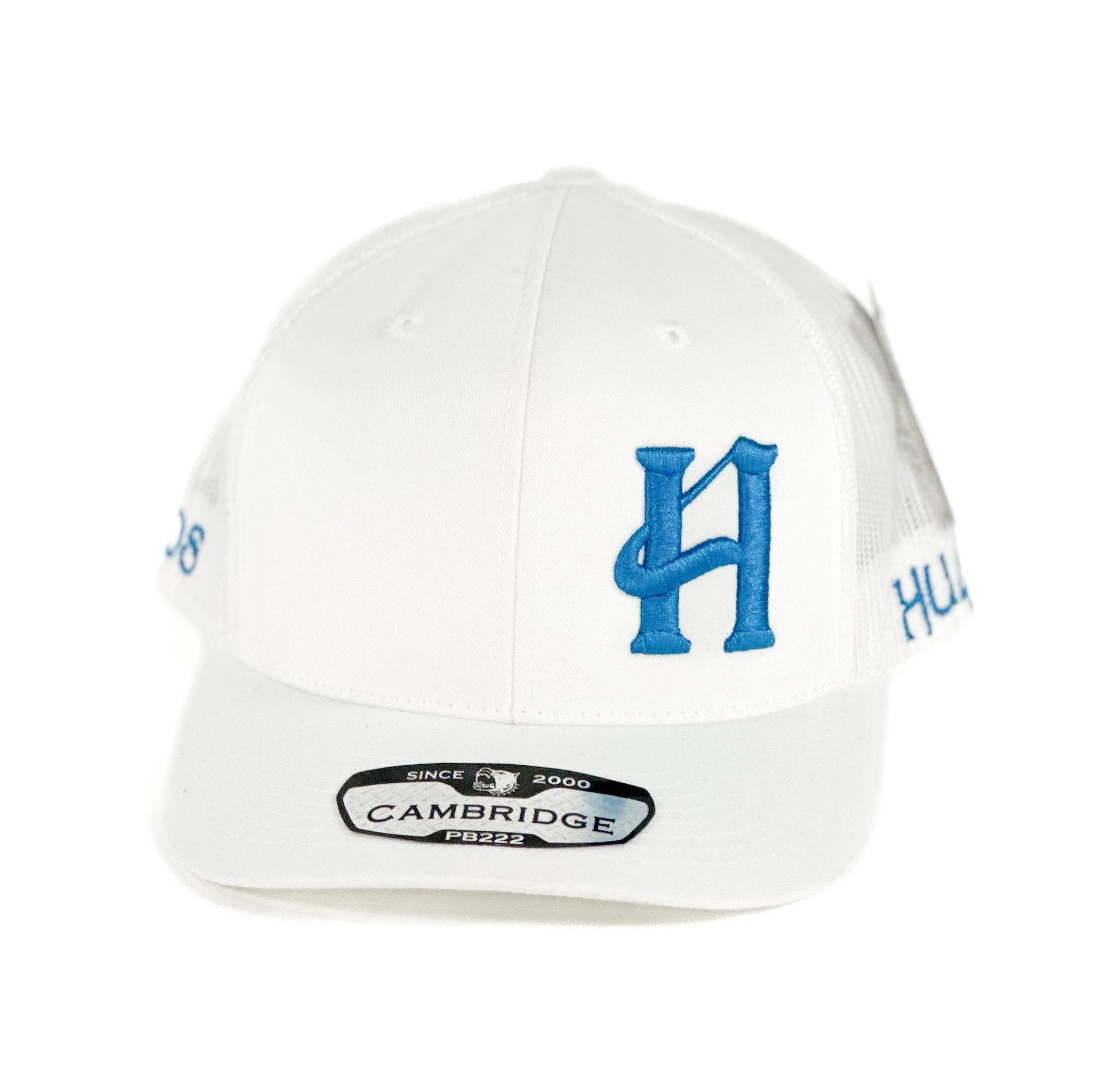 White trucker cap with blue H cuadra piedreros logo