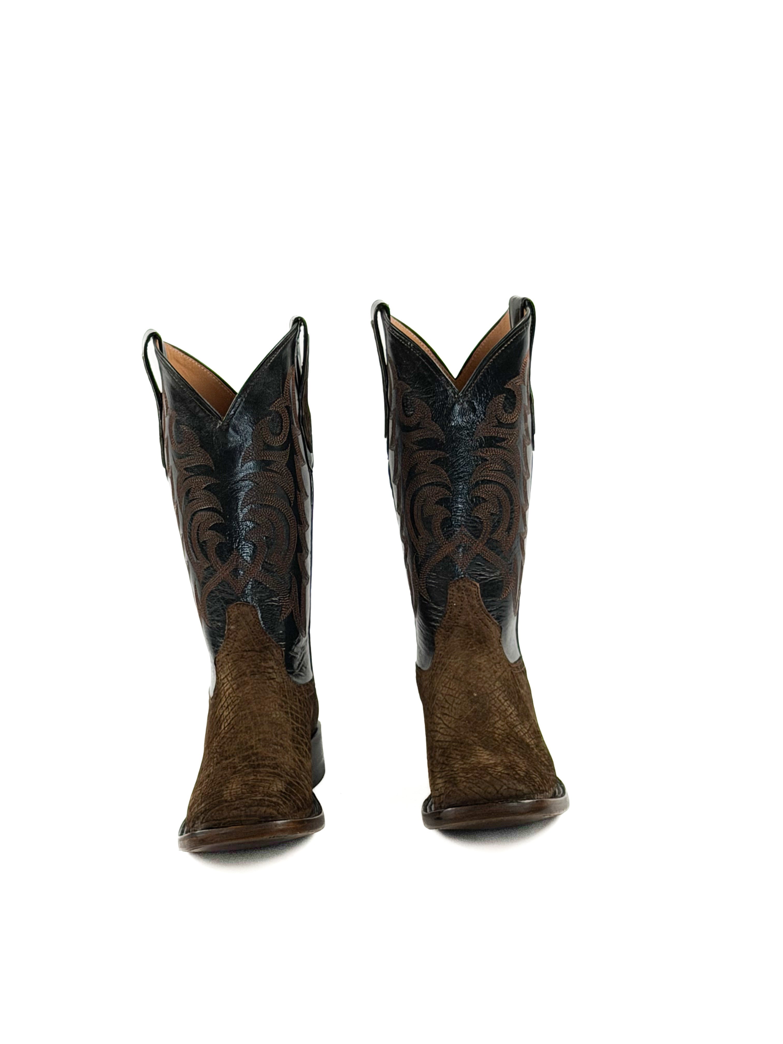 Pair of dark brown cowboy boots with intricate designs on the upper shafts
