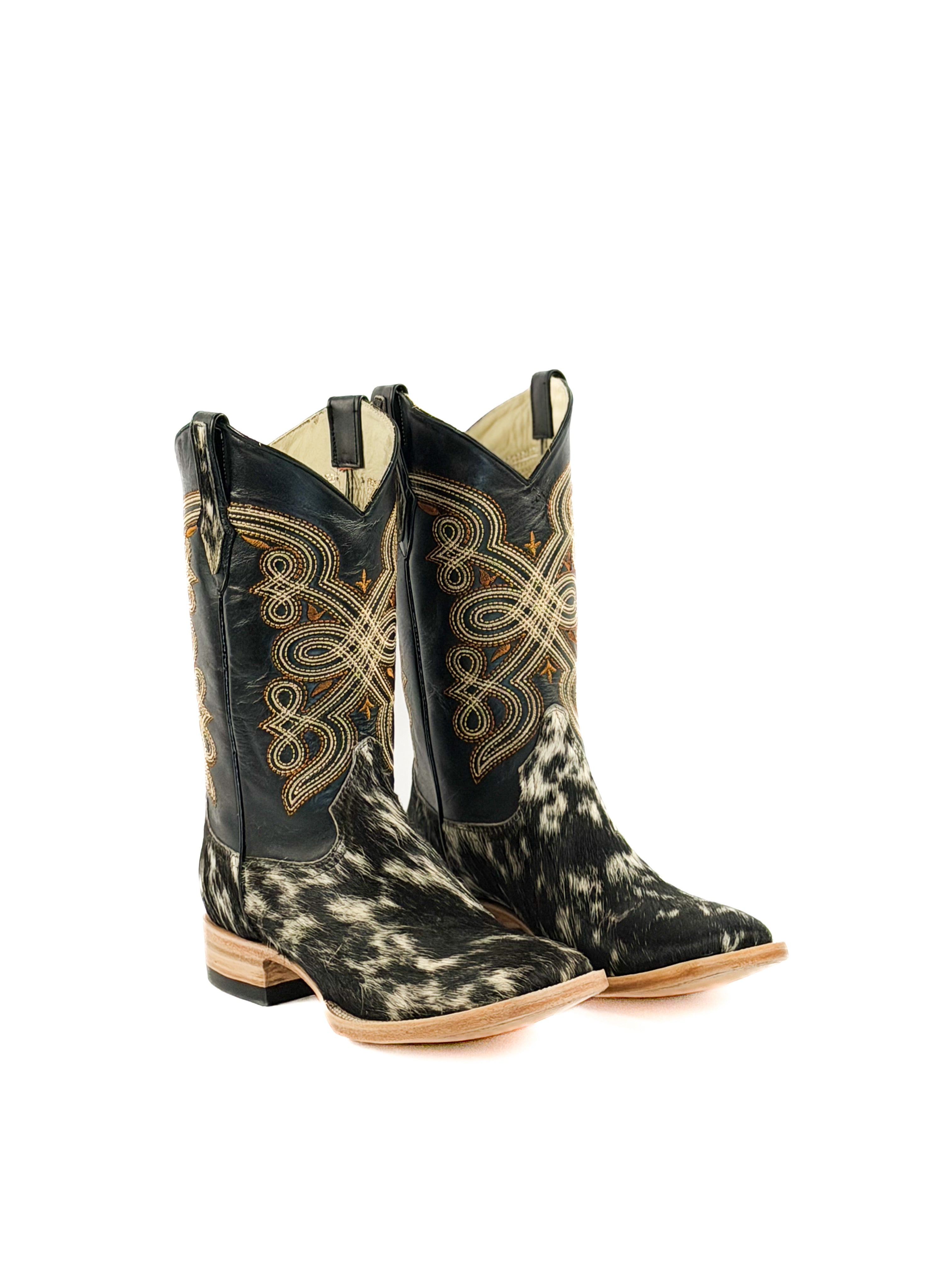 Pair of black and white cowhide square toe boots with intricate designs a black shaft