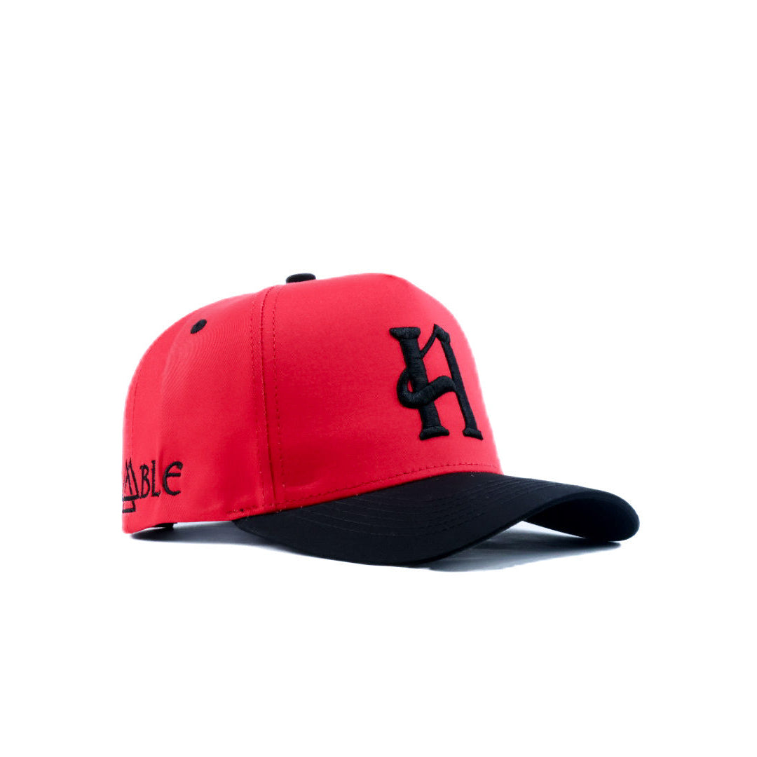 Red and black cap with a logo on a white background