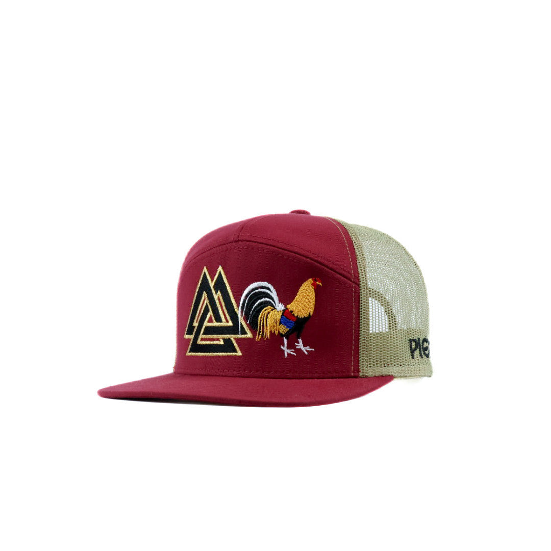 Red and gold cap with rooster and triangle logo piedreros