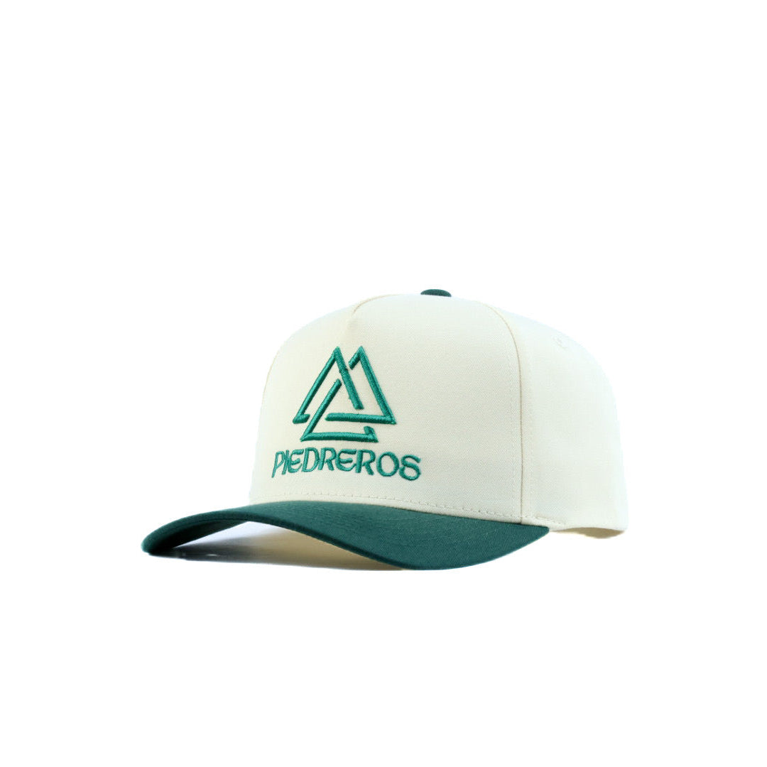 White cap with green piedreros logo and text on a white background
