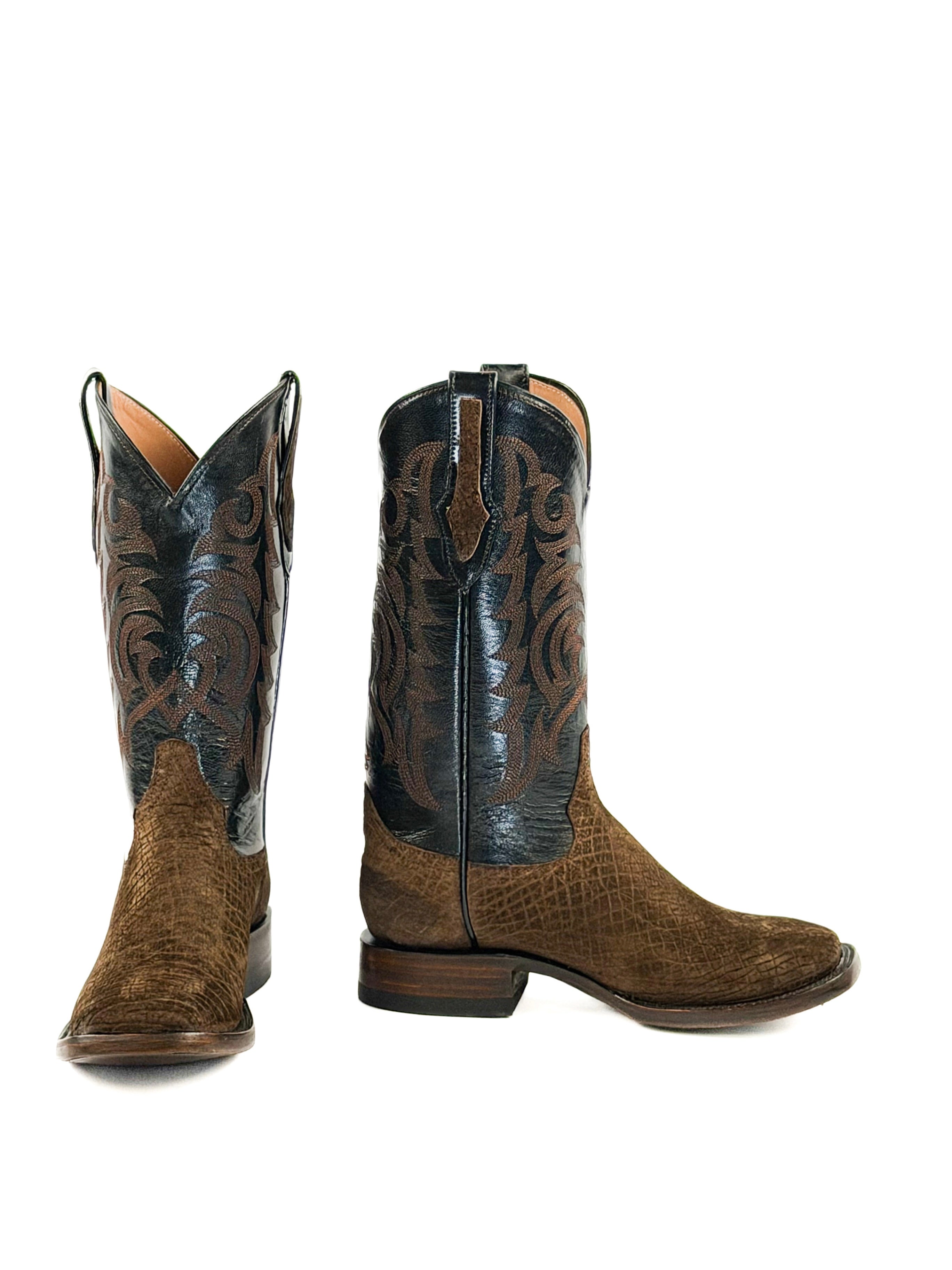 Pair of dark brown cowboy boots with black leather upper shafts