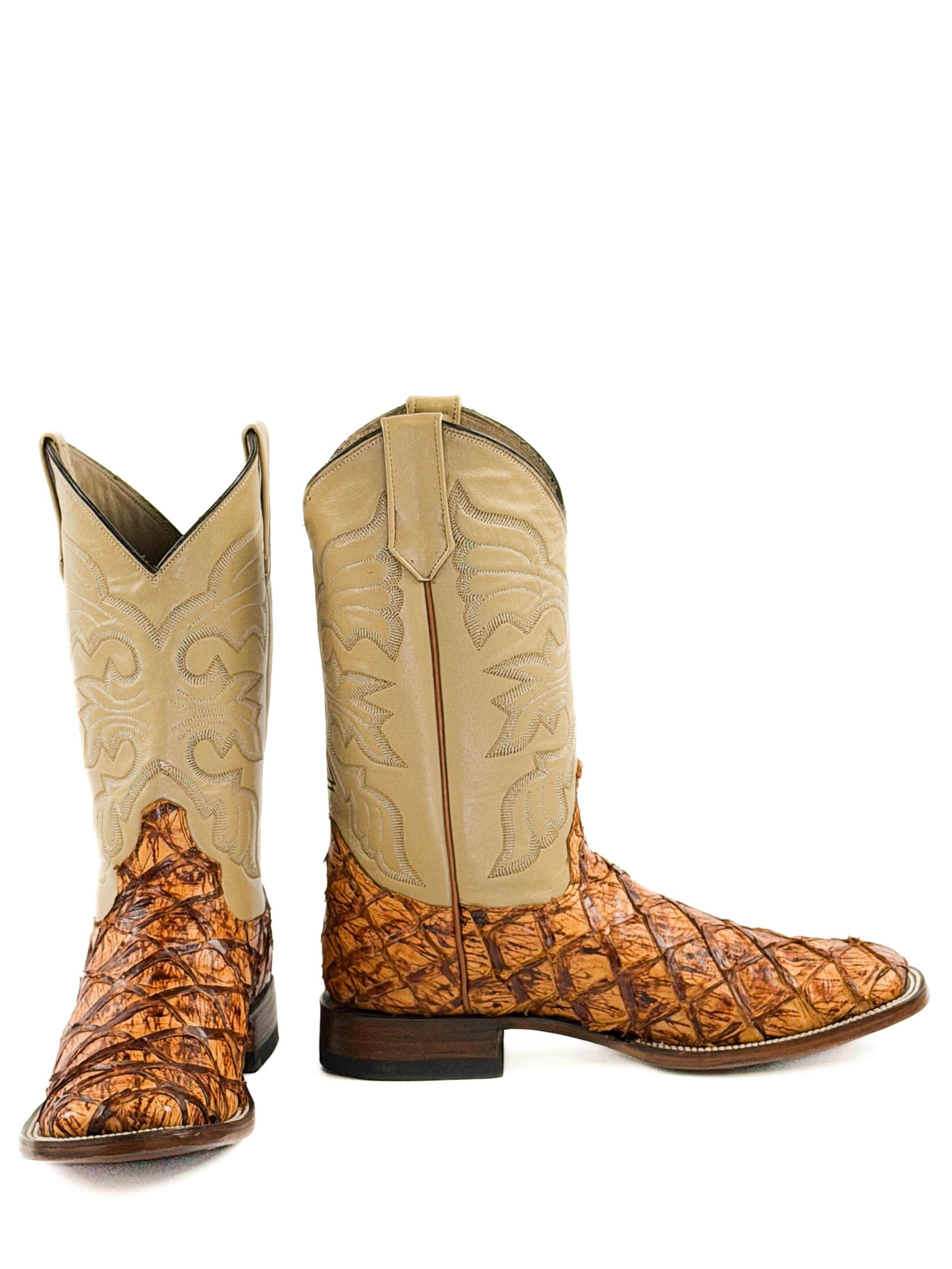 Pair of orange and brown cowboy boots with stitching design on the upper shafts