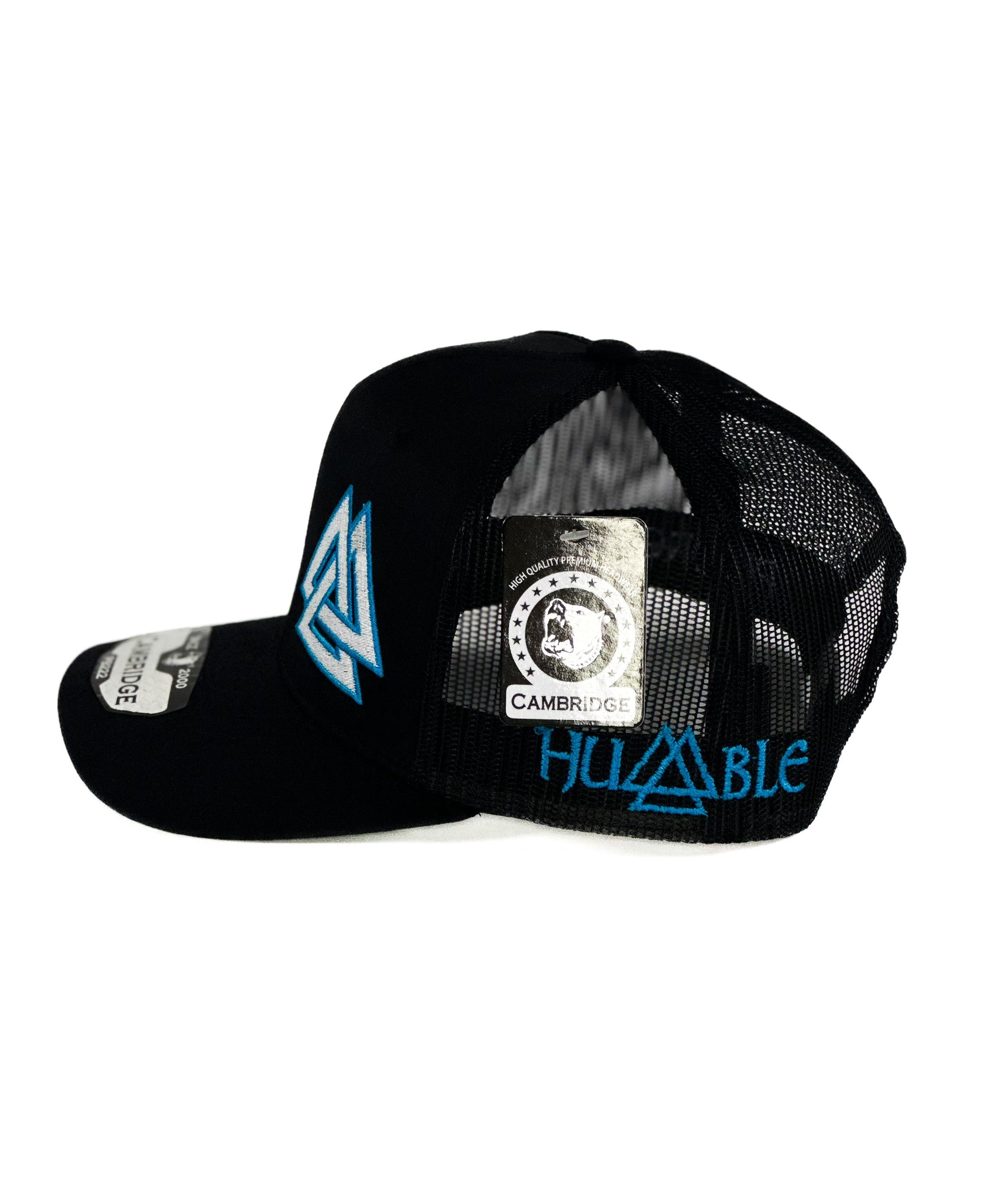 Black cap with a blue and white triangle cuadra piedreros logo