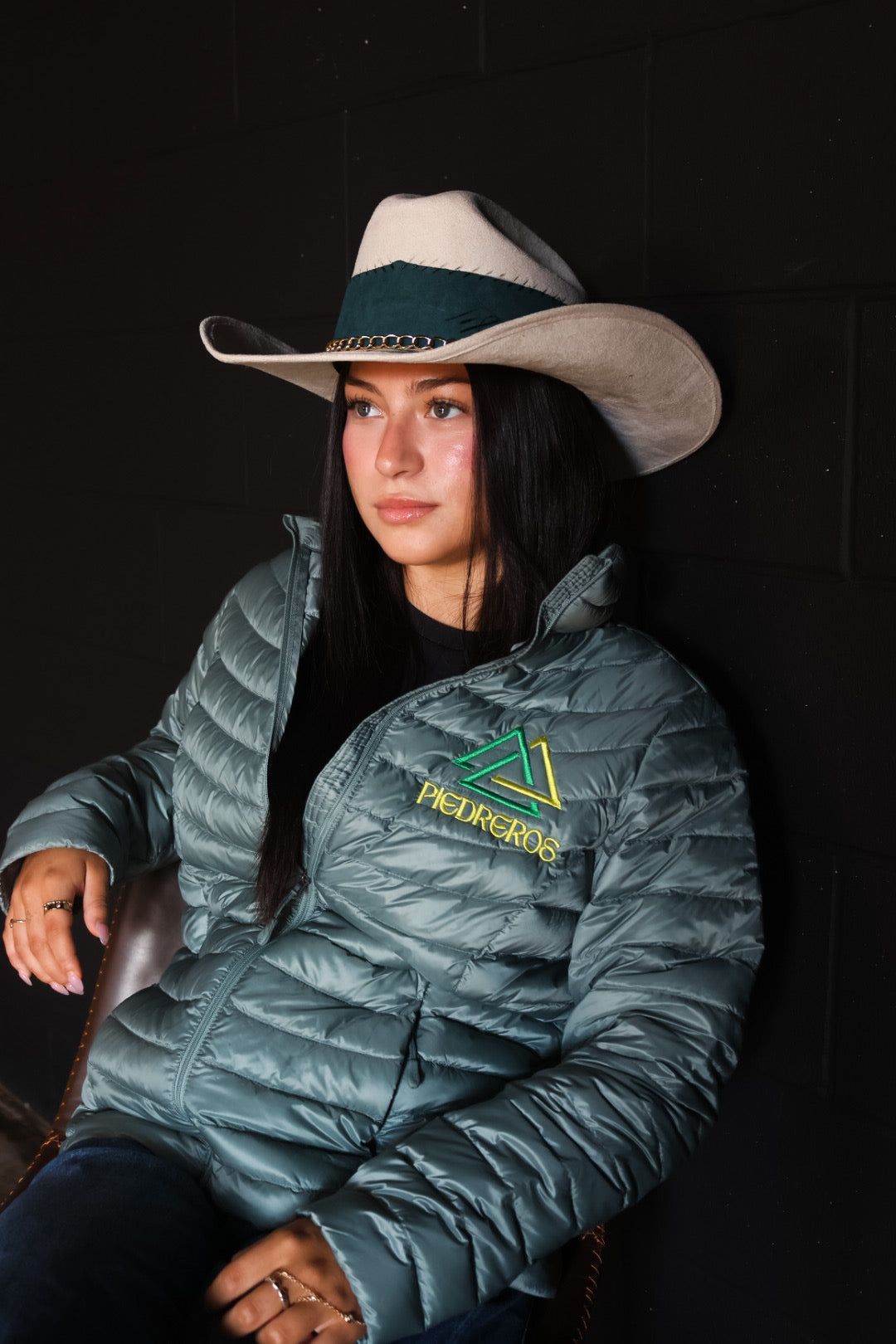 Model wearing piedreros jacket and cream cowgirl hat